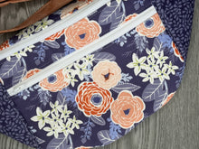 Load image into Gallery viewer, close up of fabrics Fanny Pack Large Size, Purple, Coral, peach and cream flowers with Purple and Lilac accents , Peach Fabric strap and White Zippers with Nickel Hardware 