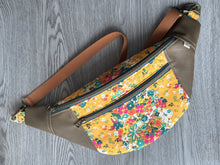 Load image into Gallery viewer, Golden Yellow Flower Print fabric with Mocha Vinyl Accent Large Fanny Pack with Caramel cotton Webbing  and Brass Hardware natural lighting