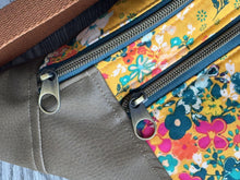 Load image into Gallery viewer, Golden Yellow Flower Print fabric with Mocha Vinyl Accent Large Fanny Pack with Caramel cotton Webbing  and Brass Hardware  close up of brass round zipper pull