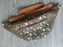 Load image into Gallery viewer,  Black multi color flower fabric with Mocha Vinyl  Large Fanny Pack with Caramel cotton Webbing  and Brass Hardware  natural light