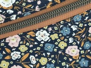 close up  Black multi color flower fabric with Mocha Vinyl  Large Fanny Pack with Caramel cotton Webbing  and Brass Hardware  with cool light